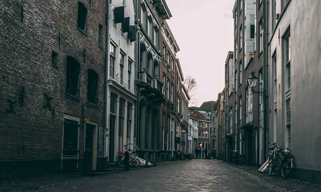Narrow city laneway between old brick buildings